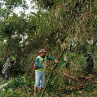 Babinsa Kelurahan Bence Ajak Warga Bersihkan Ranting Bambu Yang Menutupi Akses Jalan Persawahan